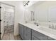 Modern bathroom with double vanity, white countertops, large mirror, and tiled floors for a sleek design at 4233 Poplin Grove Dr, Indian Trail, NC 28079