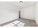 Neutral bedroom with plush carpeting, a modern ceiling fixture, and a white door at 4233 Poplin Grove Dr, Indian Trail, NC 28079