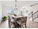 Formal dining room with modern lighting, hardwood flooring, and views of the home's entry at 4233 Poplin Grove Dr, Indian Trail, NC 28079