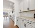 Bright kitchen with white cabinets, subway tile backsplash, and granite counters that extends into the dining area at 4233 Poplin Grove Dr, Indian Trail, NC 28079