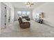 Comfortable living room showcases neutral carpeting, a sectional sofa, and a flat screen television at 4233 Poplin Grove Dr, Indian Trail, NC 28079