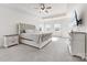 A bright main bedroom with plush carpeting, tray ceiling, and a tufted king bed at 4233 Poplin Grove Dr, Indian Trail, NC 28079