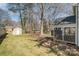 Spacious backyard featuring a large lawn, mature trees, and screen porch at 5019 Crooked Oak Ln, Charlotte, NC 28226