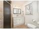 Bathroom featuring a glass-enclosed shower, large mirror, and ample storage space at 5019 Crooked Oak Ln, Charlotte, NC 28226