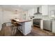 Modern kitchen featuring a spacious island, stainless steel appliances, and a seamless connection to the dining area at 5019 Crooked Oak Ln, Charlotte, NC 28226