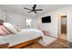 Bright bedroom with white walls, wood floors, and a view into the ensuite bathroom at 5019 Crooked Oak Ln, Charlotte, NC 28226