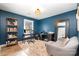 Comfortable home office with a cozy sitting area, large window, and dark blue paint at 5019 Crooked Oak Ln, Charlotte, NC 28226