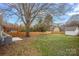 A spacious backyard featuring a privacy fence, large shade tree and a cozy pergola at 504 Leland St, Charlotte, NC 28214