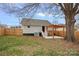 A spacious backyard featuring a privacy fence, large shade tree and a cozy pergola at 504 Leland St, Charlotte, NC 28214