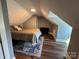 Cozy bedroom featuring sloped ceilings, wood floors, and a decorative area rug under the bed at 504 Leland St, Charlotte, NC 28214