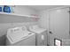 Bright laundry room features a washer, dryer, and storage shelves for added convenience and organization at 504 Leland St, Charlotte, NC 28214