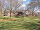 Sprawling backyard featuring a covered porch, mature trees, and a lush lawn perfect for outdoor activities at 5789 Gettysburg Nw Dr, Concord, NC 28027