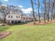 Charming home featuring a well-manicured lawn, covered front porch, and brick accents at 5789 Gettysburg Nw Dr, Concord, NC 28027