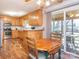 Eat-in kitchen boasts oak cabinets, breakfast bar, and access to a screened porch at 5789 Gettysburg Nw Dr, Concord, NC 28027