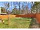 Expansive backyard with privacy fence, lush lawn, and a cozy fire pit at 5830 Kelden Walker Ln, Charlotte, NC 28269