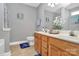 Bathroom with double vanity sink, wood cabinets, and neutral color scheme at 5830 Kelden Walker Ln, Charlotte, NC 28269