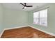 A bright bedroom features wood flooring and a window with natural light at 5830 Kelden Walker Ln, Charlotte, NC 28269