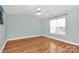 A bright bedroom features hardwood floors, a ceiling fan, and a sunny window at 5830 Kelden Walker Ln, Charlotte, NC 28269