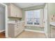 Cozy breakfast nook with white cabinets, quartz countertops, complemented by tile flooring and natural light at 5830 Kelden Walker Ln, Charlotte, NC 28269