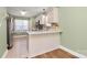 Well-lit kitchen with a breakfast bar, ample cabinet space, and stainless steel refrigerator at 5830 Kelden Walker Ln, Charlotte, NC 28269