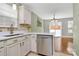 Modern kitchen featuring stainless steel appliances, white cabinets, and a view into the dining area and backyard at 5830 Kelden Walker Ln, Charlotte, NC 28269