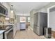 Well-lit kitchen with stainless steel appliances, white cabinets, and tile flooring at 5830 Kelden Walker Ln, Charlotte, NC 28269