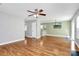 Open-concept living room with hardwood floors flowing into the kitchen and dining area at 5830 Kelden Walker Ln, Charlotte, NC 28269