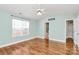 Large main bedroom with hardwood floors, ceiling fan, and ensuite bathroom at 5830 Kelden Walker Ln, Charlotte, NC 28269