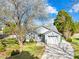 Charming single-Gathering home featuring a well-manicured lawn and a blossoming tree in a suburban neighborhood at 6325 Martin Lake Rd, Charlotte, NC 28227