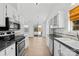 Modern kitchen with white cabinets, granite countertops, stainless steel appliances, and hardwood flooring at 6325 Martin Lake Rd, Charlotte, NC 28227