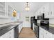 Modern kitchen with white cabinets, granite countertops, stainless steel appliances, and hardwood flooring at 6325 Martin Lake Rd, Charlotte, NC 28227