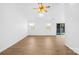 Spacious living room featuring neutral paint, hardwood floors, ceiling fan and lots of natural light through large windows at 6325 Martin Lake Rd, Charlotte, NC 28227