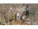 Aerial view of a two-story home with a brick and siding facade and mature trees at 717 Meadow Lake Dr, Matthews, NC 28105