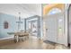 Open-concept dining area with modern chandelier, light wood flooring, and bright natural light at 717 Meadow Lake Dr, Matthews, NC 28105