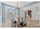 Bright dining room with a modern chandelier, large windows, and hardwood floors at 717 Meadow Lake Dr, Matthews, NC 28105