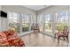 Sunroom with hardwood floors, large windows and views of the private, tree-lined backyard at 717 Meadow Lake Dr, Matthews, NC 28105