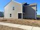 View of the backyard showing the sodded lot and the siding on the house at 812 N Naughton St, Chester, SC 29706