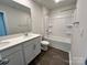 Bathroom featuring double sink vanity, framed mirror, and tile surround shower at 812 N Naughton St, Chester, SC 29706