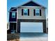 Two story home with a two car garage, combination siding and brick exterior and newly installed landscaping at 812 N Naughton St, Chester, SC 29706