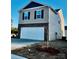 Two story home with a two car garage, combination siding and brick exterior and newly installed landscaping at 812 N Naughton St, Chester, SC 29706