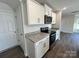 Close up view of the kitchen showing the granite countertops and white cabinets at 812 N Naughton St, Chester, SC 29706