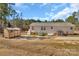 Exterior view of the back of house with shed and large green house and blue sky in the background at 8742 Belt Ln, Fort Mill, SC 29707