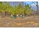 Backyard with a circled fire pit and green and white striped outdoor chairs at 8742 Belt Ln, Fort Mill, SC 29707