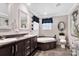 Bathroom with double vanity, garden tub, dark wood accents, and modern fixtures at 8742 Belt Ln, Fort Mill, SC 29707