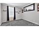 This bedroom is bright and airy, featuring crown molding, gray paint and carpet, and black accents at 8742 Belt Ln, Fort Mill, SC 29707