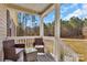 Relaxing covered porch featuring comfortable outdoor seating, perfect for enjoying the surrounding nature at 8742 Belt Ln, Fort Mill, SC 29707