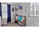 Cozy entryway with cushioned bench, decorative pillows, unique wall art and dark blue curtains and an area rug at 8742 Belt Ln, Fort Mill, SC 29707