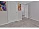 Hallway and doors with gray walls and carpet and paintings hanging on the wall at 8742 Belt Ln, Fort Mill, SC 29707