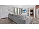 Cozy living room with a large gray sectional sofa, complemented by shelving, and soft natural light at 8742 Belt Ln, Fort Mill, SC 29707