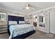 Elegant bedroom with a plush, tufted headboard, mirrored accents, and ample natural light at 8742 Belt Ln, Fort Mill, SC 29707